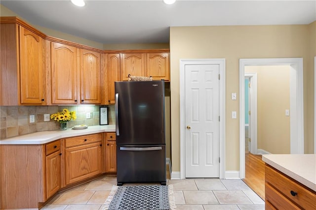 223 Oak Grove Dr, Dallas, GA 30157 - kitchen featuring freestanding refrigerator, light countertops, light tile patterned flooring, decorative backsplash, and recessed lighting