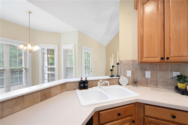 223 Oak Grove Dr, Dallas, GA 30157 - kitchen featuring light countertops, a sink, hanging light fixtures, backsplash, and vaulted ceiling