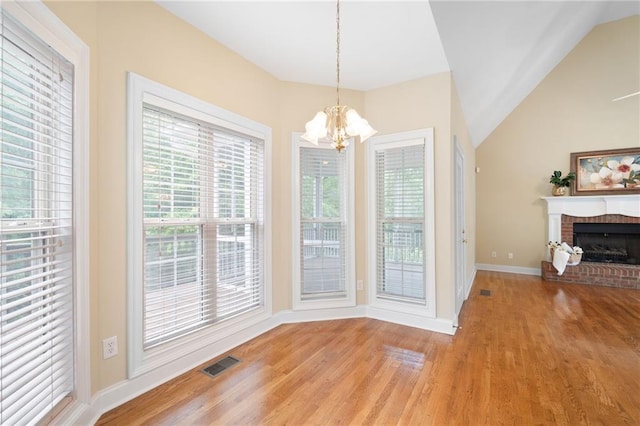 223 Oak Grove Dr, Dallas, GA 30157 - unfurnished dining area featuring a chandelier, light wood-style flooring, baseboards, and a fireplace