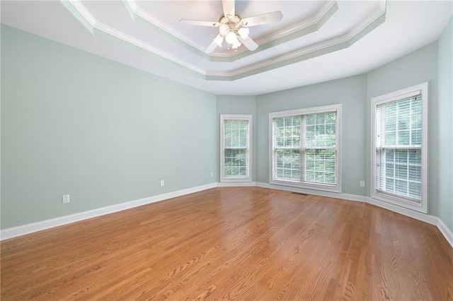 223 Oak Grove Dr, Dallas, GA 30157 - empty room with a tray ceiling, ornamental molding, light wood-type flooring, a ceiling fan, and baseboards