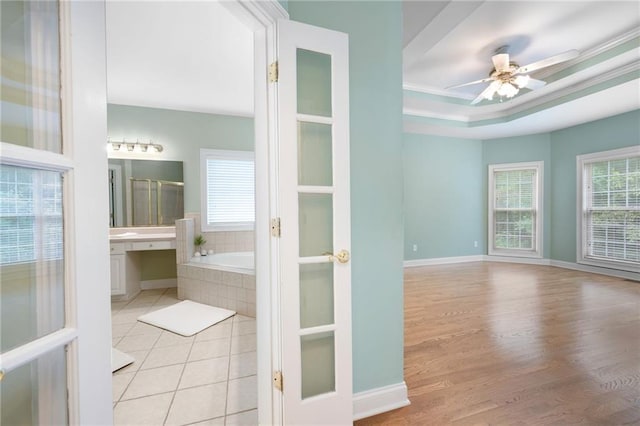 223 Oak Grove Dr, Dallas, GA 30157 - bathroom with a bath, a ceiling fan, wood finished floors, baseboards, and a tray ceiling