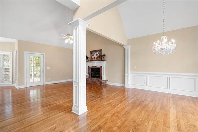 223 Oak Grove Dr, Dallas, GA 30157 - unfurnished living room featuring ornate columns, light wood-type flooring, a ceiling fan, a fireplace, and high vaulted ceiling