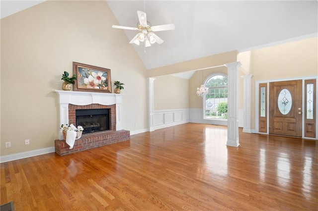 223 Oak Grove Dr, Dallas, GA 30157 - unfurnished living room featuring ornate columns, high vaulted ceiling, a fireplace, a ceiling fan, and wood finished floors