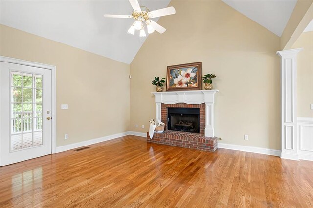 223 Oak Grove Dr, Dallas, GA 30157 - unfurnished living room with a brick fireplace, light wood-style flooring, a ceiling fan, high vaulted ceiling, and baseboards