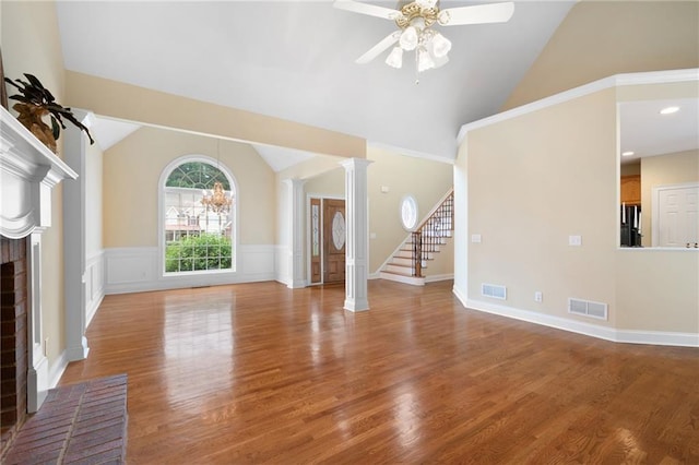 223 Oak Grove Dr, Dallas, GA 30157 - unfurnished living room with ceiling fan, wood finished floors, a fireplace, stairway, and a wainscoted wall