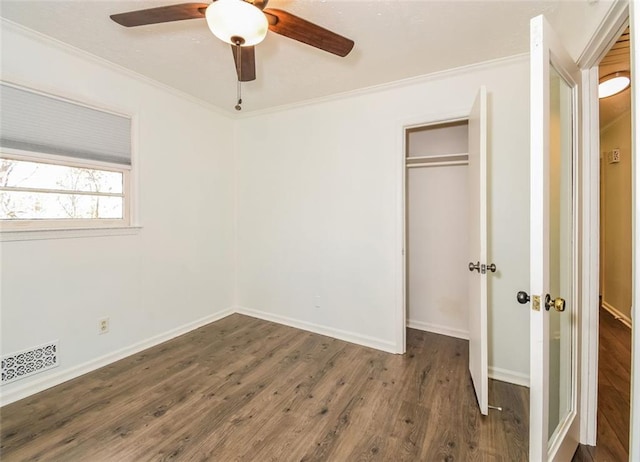 unfurnished bedroom with dark hardwood / wood-style floors, ceiling fan, and crown molding