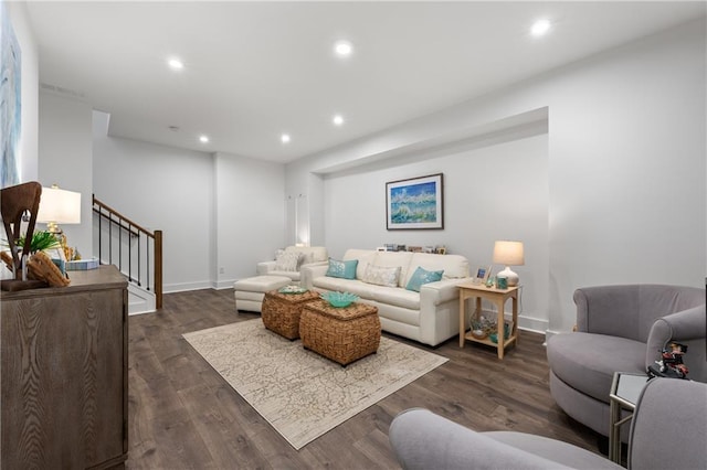 living room featuring stairs, recessed lighting, dark wood-style flooring, and baseboards