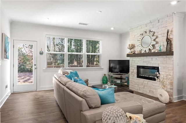 living area featuring a wealth of natural light, wood finished floors, and ornamental molding