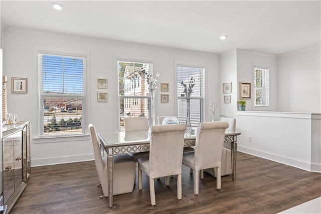 dining space with a healthy amount of sunlight, ornamental molding, baseboards, and dark wood-style flooring