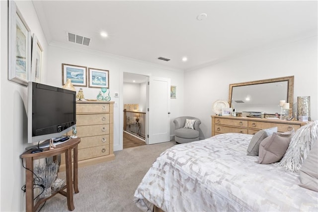 carpeted bedroom with visible vents, recessed lighting, and ornamental molding