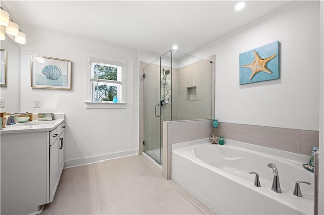 bathroom featuring recessed lighting, a shower stall, baseboards, a bath, and vanity