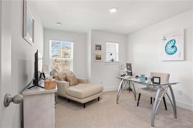 office featuring a wealth of natural light, baseboards, and light carpet