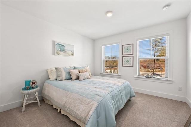 carpeted bedroom with baseboards