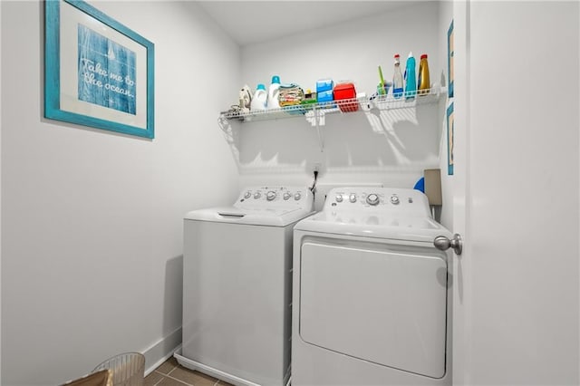 laundry area featuring laundry area, baseboards, independent washer and dryer, and tile patterned floors