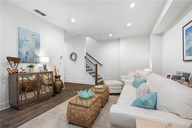 living room with visible vents, wood finished floors, recessed lighting, stairway, and baseboards