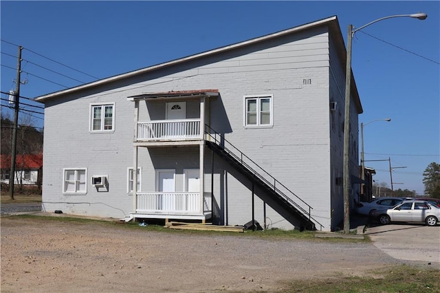 rear view of house featuring brick siding