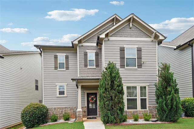 5925 Watersdown Way, Flowery Branch, GA 30542 - craftsman house featuring stone siding and a front yard
