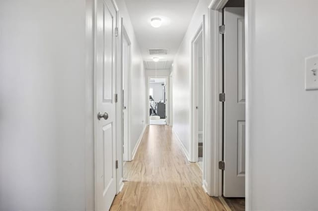 5925 Watersdown Way, Flowery Branch, GA 30542 - hallway featuring attic access, light wood finished floors, and baseboards