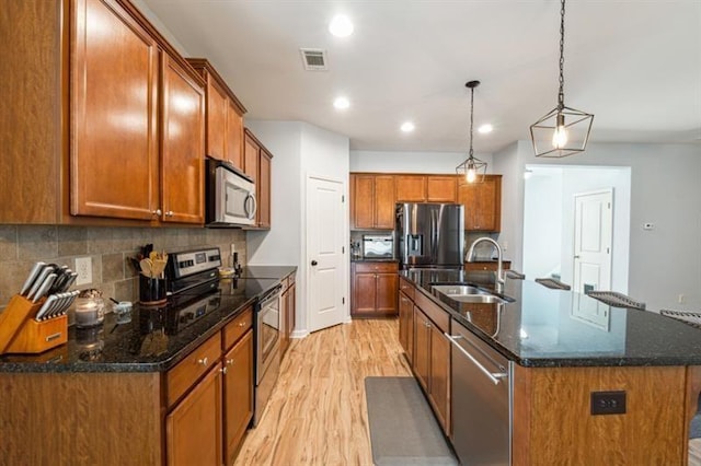 5925 Watersdown Way, Flowery Branch, GA 30542 - kitchen featuring appliances with stainless steel finishes, a sink, light wood-type flooring, brown cabinets, and recessed lighting