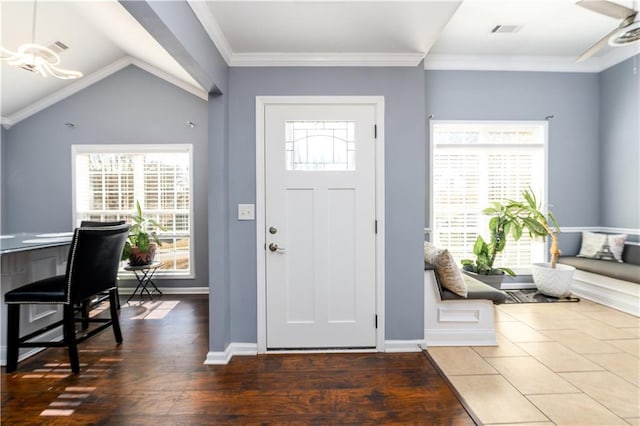 entryway with visible vents, baseboards, a ceiling fan, ornamental molding, and wood finished floors