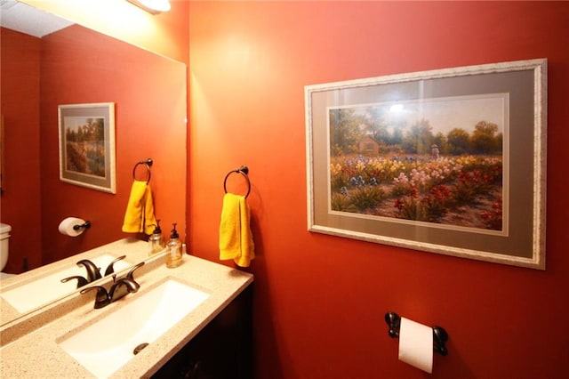 bathroom featuring vanity and toilet