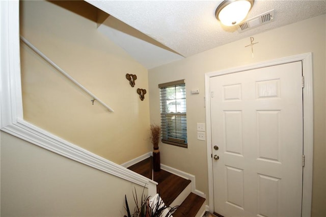 entryway featuring hardwood / wood-style floors and a textured ceiling