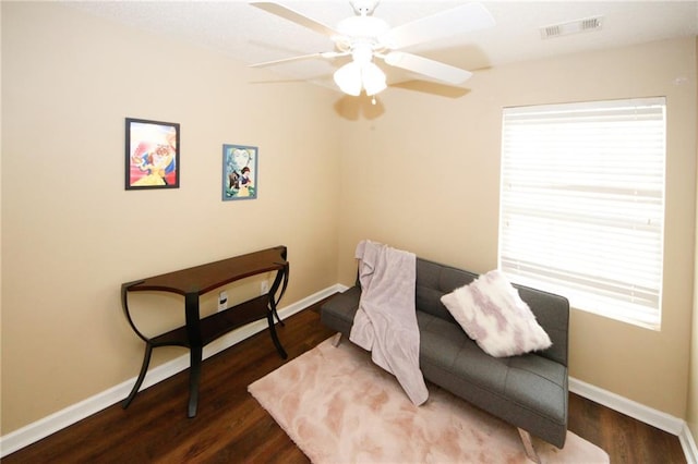 living area with hardwood / wood-style flooring and ceiling fan