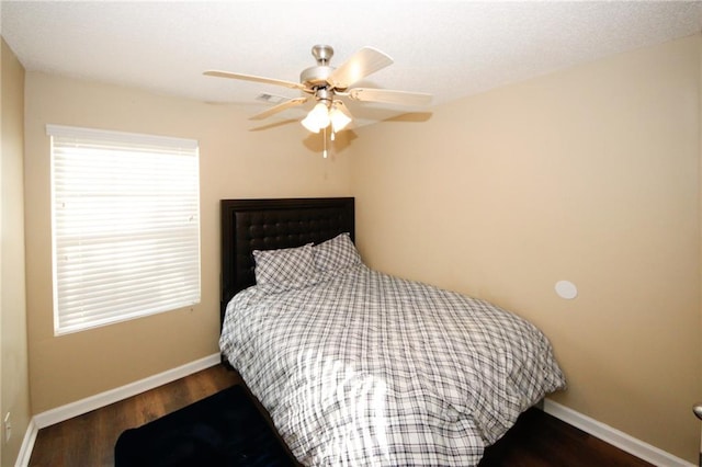 bedroom featuring dark hardwood / wood-style flooring and ceiling fan