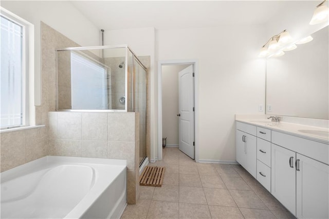 bathroom featuring tile patterned flooring, vanity, and separate shower and tub