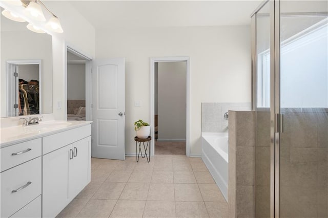 bathroom with independent shower and bath, vanity, and tile patterned floors