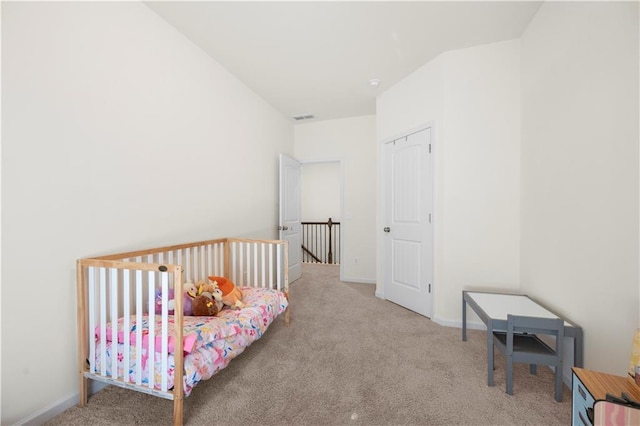 bedroom featuring light carpet