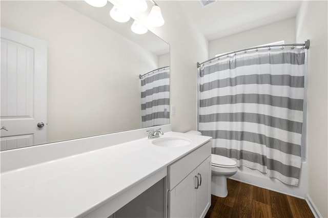 full bathroom with vanity, shower / tub combo, hardwood / wood-style flooring, and toilet