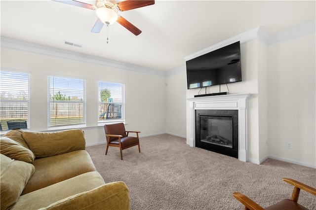 living room with ceiling fan, light colored carpet, and ornamental molding