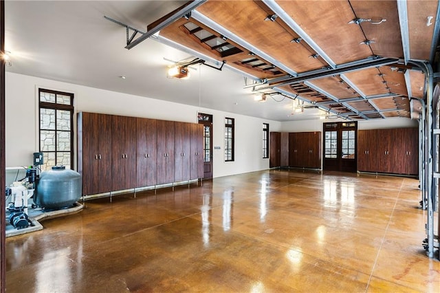 garage with a garage door opener and french doors