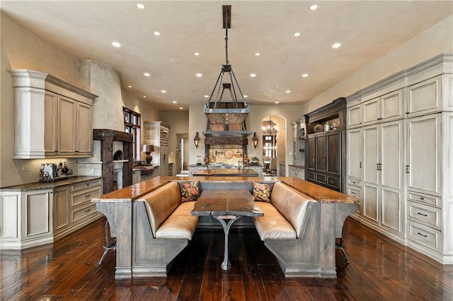 kitchen featuring cream cabinetry, a large island, breakfast area, and decorative light fixtures