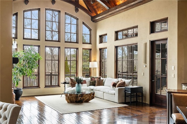 sunroom with lofted ceiling with beams and wooden ceiling