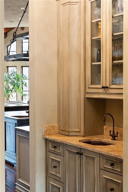 bar featuring a sink and wood finished floors