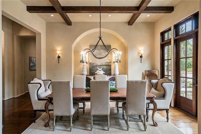 dining space featuring coffered ceiling, wood finished floors, an inviting chandelier, beam ceiling, and recessed lighting