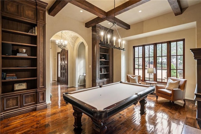 playroom featuring built in features, arched walkways, dark wood-style flooring, coffered ceiling, and beamed ceiling