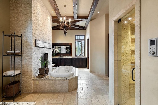 full bathroom featuring stone tile floors, beamed ceiling, a whirlpool tub, vanity, and a shower stall