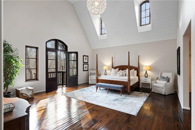 bedroom featuring baseboards, high vaulted ceiling, and dark wood-type flooring