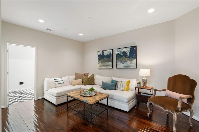 living area with baseboards, visible vents, dark wood finished floors, and recessed lighting