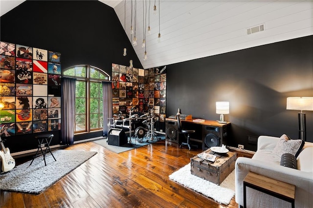 living room featuring high vaulted ceiling, visible vents, and wood finished floors