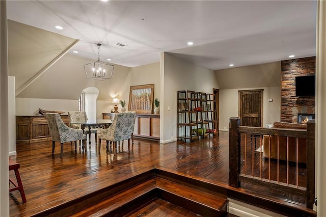 dining room with visible vents, wood finished floors, vaulted ceiling, a chandelier, and recessed lighting