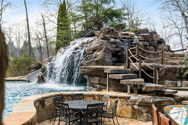 exterior space featuring a pool and outdoor dining space