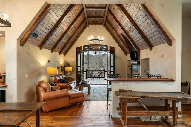 sitting room featuring beamed ceiling, wooden ceiling, wood finished floors, and an inviting chandelier