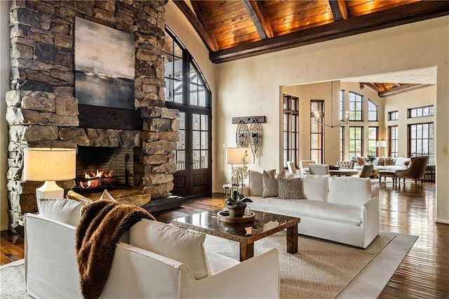 living room with wooden ceiling, a fireplace, beam ceiling, and wood finished floors