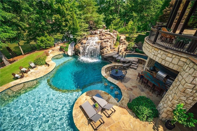 view of swimming pool with a patio area and a jacuzzi