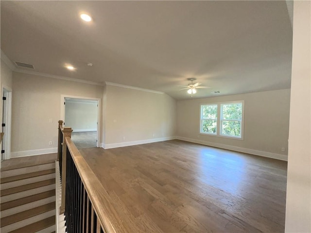 spare room featuring ceiling fan, dark hardwood / wood-style flooring, and crown molding