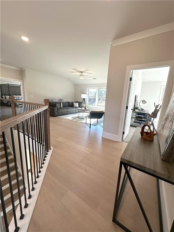 corridor featuring crown molding and light hardwood / wood-style flooring